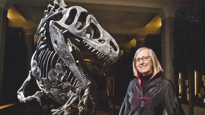 Gerta Keller standing with the baby Allosaurus dinosaur in Guyot Hall